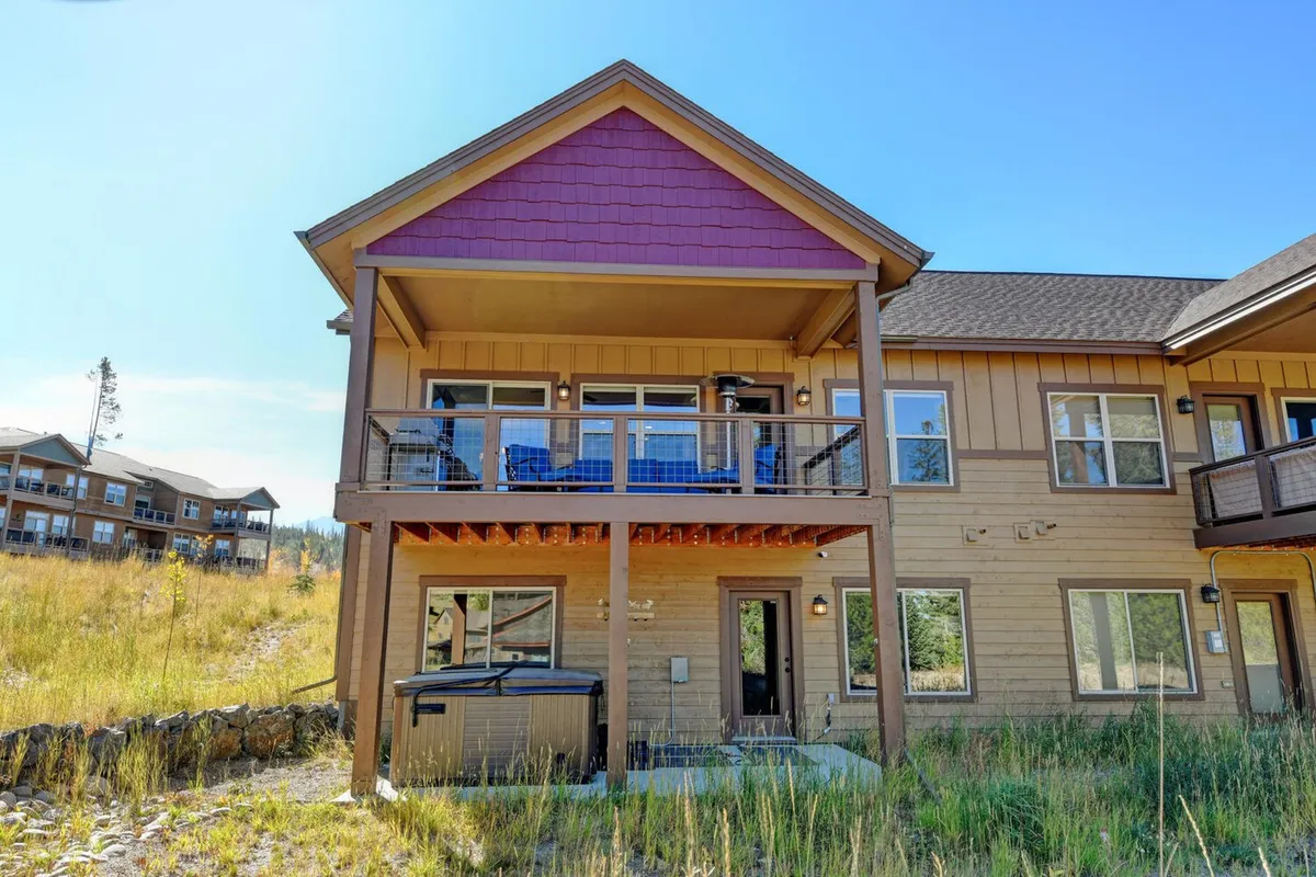 This image displays an inviting exterior balcony with views of a landscaped area, framed by the property's exterior walls. The serene setting features space for relaxation and gatherings, emphasizing a well-cared-for outdoor environment. There are no signs of animal presence, supporting the idea of a meticulously maintained, allergy-conscious property.